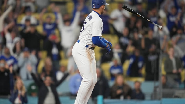 Los Angeles Dodgers' Trayce Thompson (25) tosses his bat as...