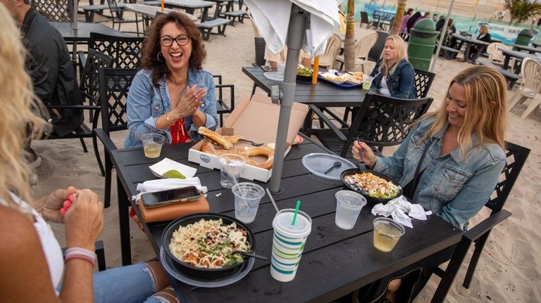 Amy Karrol, of Garden City, left, Evelyn Martinez, of Islip...