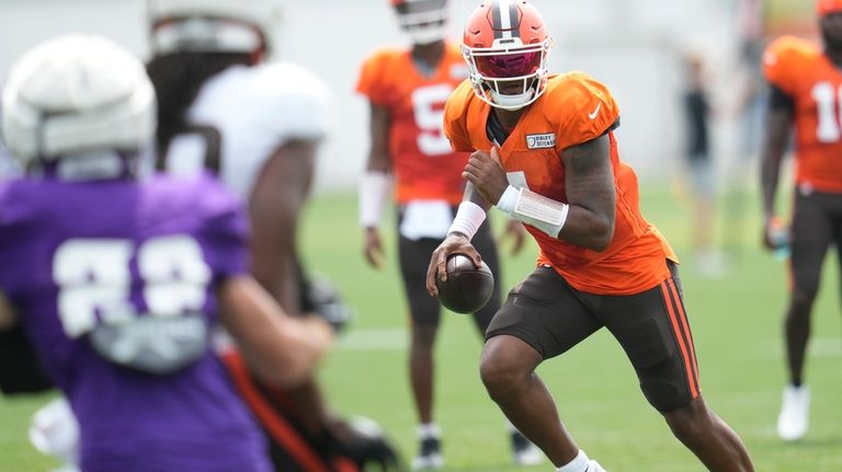 Cleveland Browns quarterback Deshaun Watson, right, scrambles during a joint...