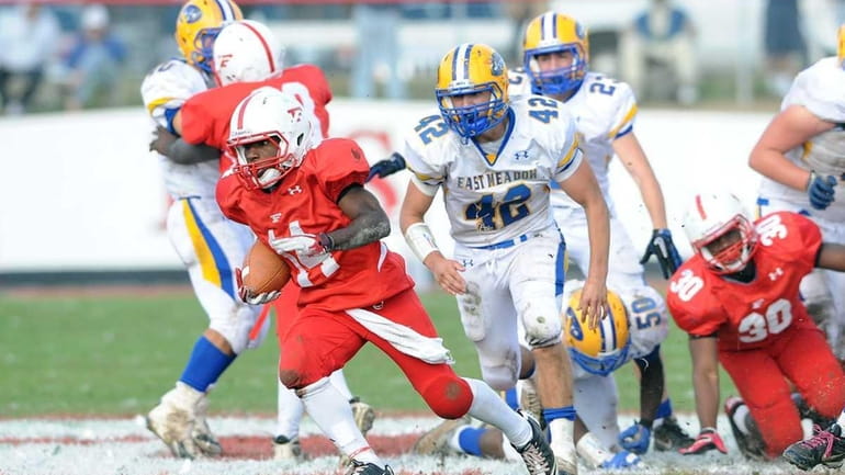 Freeport's #14 Maurice Irby runs for additional yardage during second...