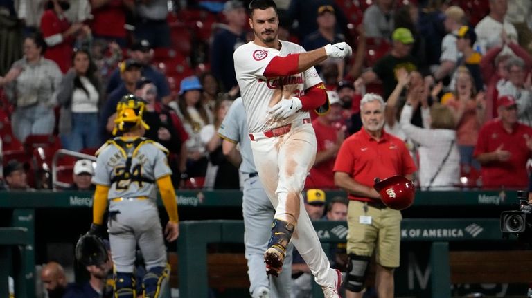 St. Louis Cardinals' Nolan Arenado tosses his helmet after hitting...