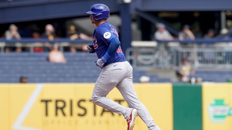 Chicago Cubs' Christian Bethancourt rounds the bases after hitting a...