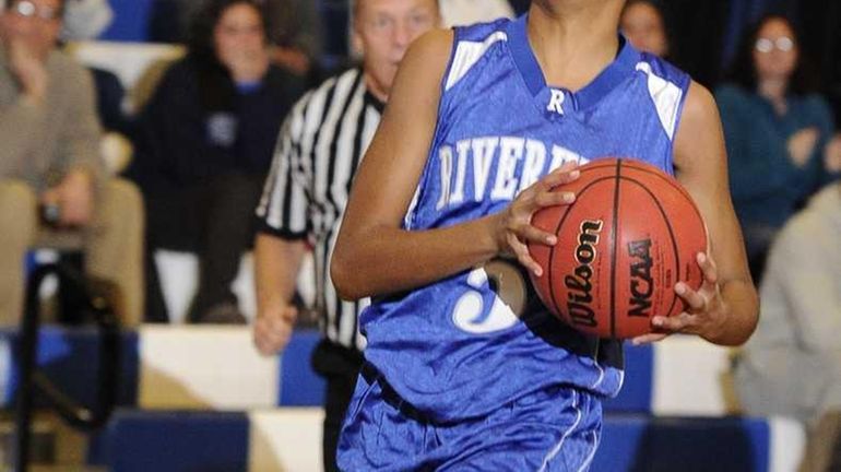 Riverhead forward Melodee Riley moves in for a layup against...