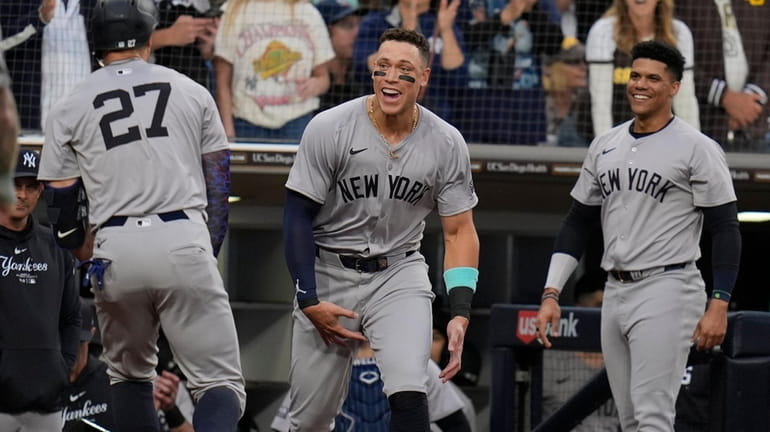 Yankees' Giancarlo Stanton (27) celebrates with teammate Aaron Judge, center,...
