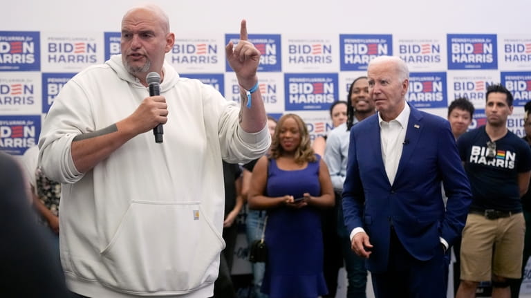 President Joe Biden, right, listens as Sen. John Fetterman, D-Pa.,...