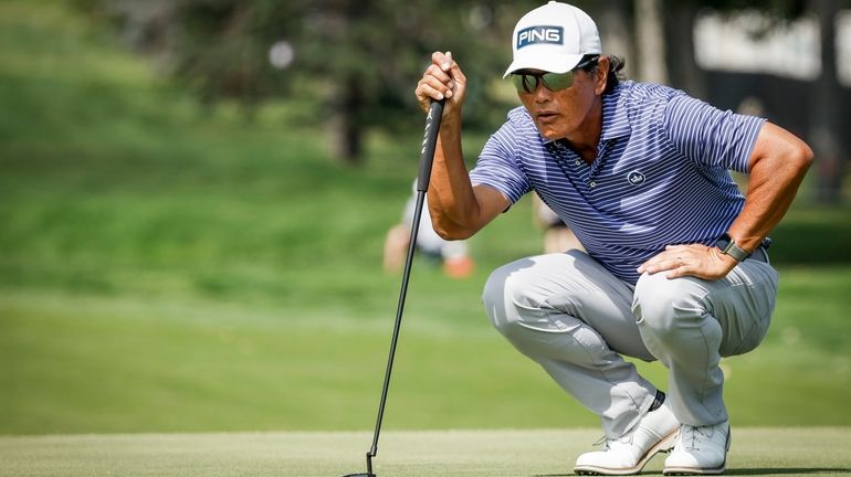 Ken Tanigawa, of the United States, lines up a putt...