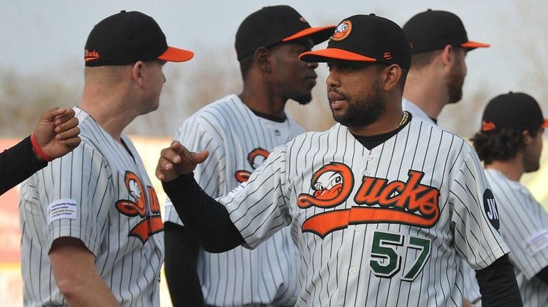 Newly signed Long Island Ducks pitcher Francisco Rodriguez greets teammates...