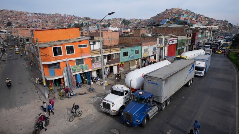 Truckers block a street to protest against a government-announced increase...