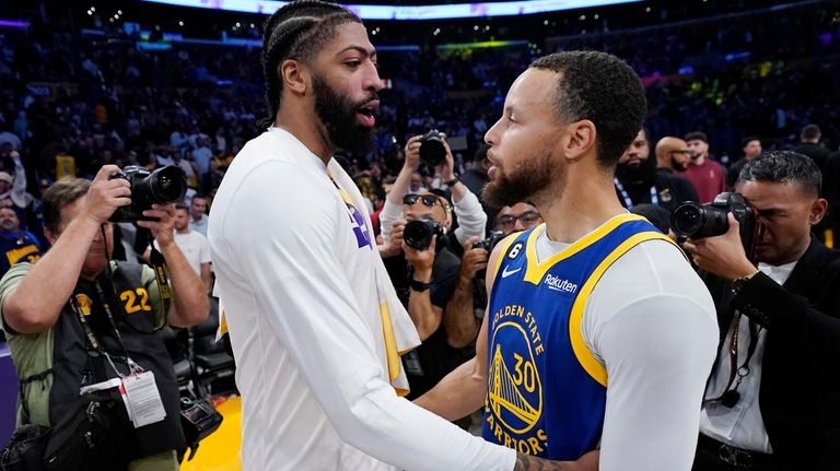 Los Angeles Lakers forward Anthony Davis, left, hugs guard Stephen...