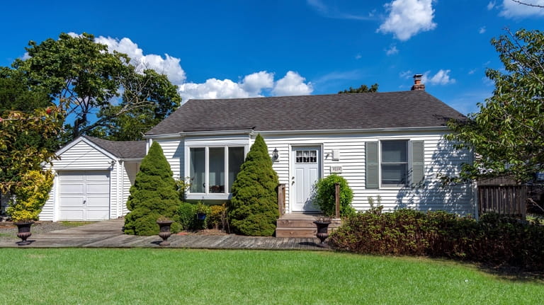 Priced at $499,000, this ranch on Pine Neck Avenue features...