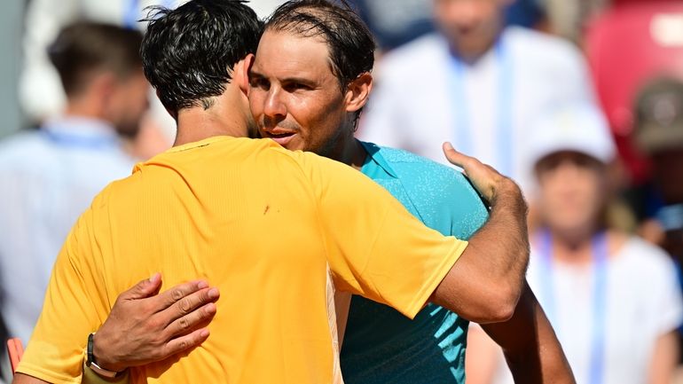 Portugal's Nuno Borges, left, hugs Spain's Rafael Nadal, right, after...