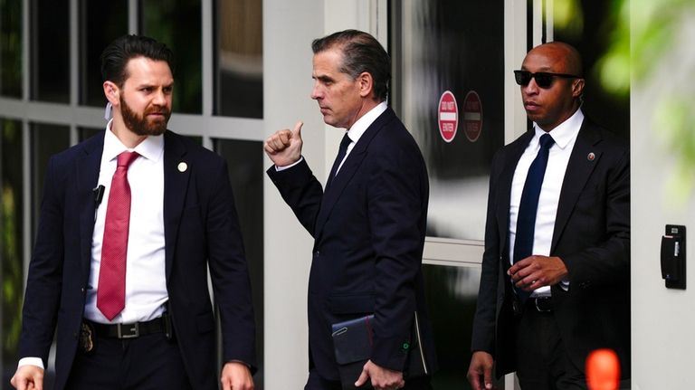 Hunter Biden, center, departs from federal court, Monday, June 10,...