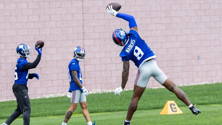 Giants wide receiver Malik Nabers makes a catch during training...