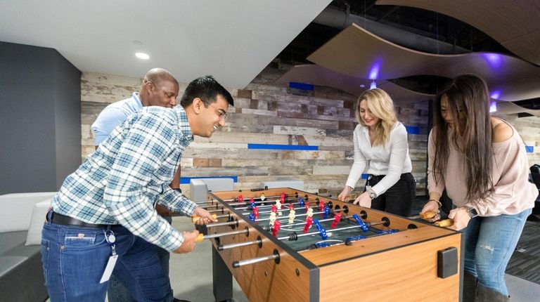 Employees Vladimir Kebreau, Yogesh Jagdale, Senada Bajraktarevic and Norica Ecker play...