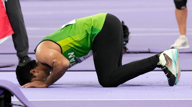 Arshad Nadeem, of Pakistan, celebrates after winning the men's javelin...