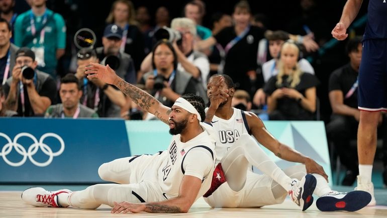 United States' LeBron James (6) draws the foul after scoring...