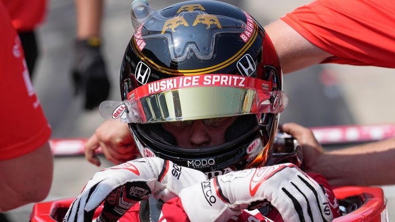 Marcus Ericsson, of Sweden, climbs out of his car during...