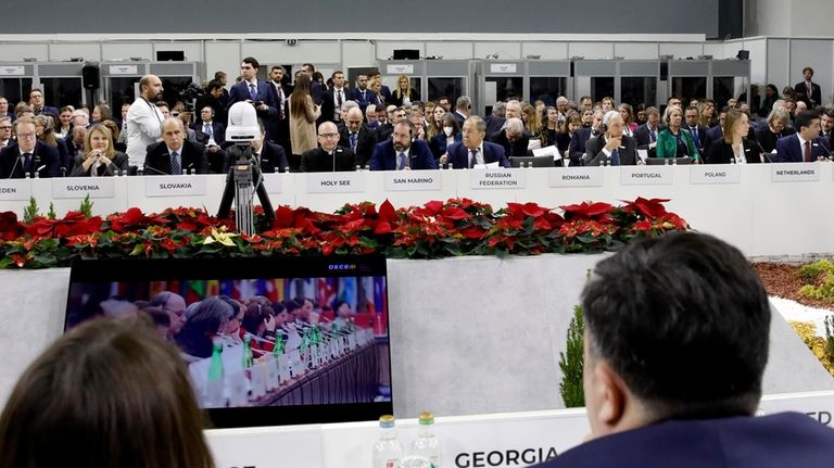 Russia's Foreign Minister Sergey Lavrov, center right in rear row,...