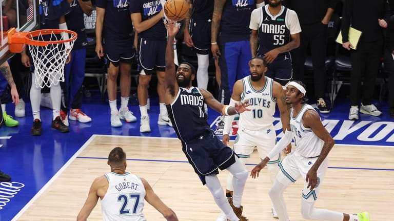 Dallas Mavericks guard Kyrie Irving (11) drives to the basket...