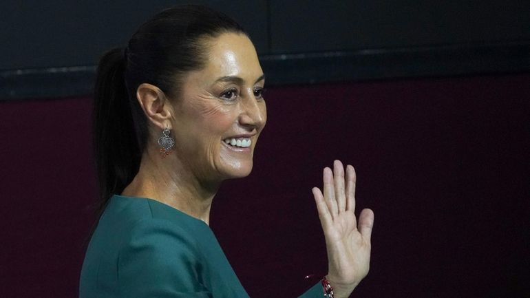 Incoming President Claudia Sheinbaum waves at the end of a...