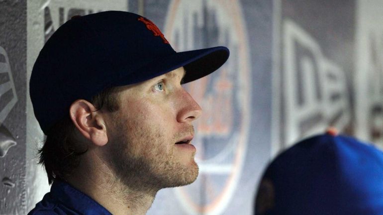 Jason Bay sits in the dugout during a game against...