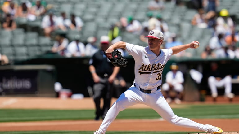 Oakland Athletics pitcher JP Sears throws to a Los Angeles...