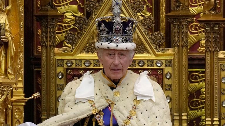 Britain's King Charles III pauses during the State Opening of...