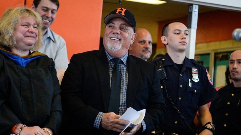 Billy Joel attends the Hicksville High School graduation ceremony on...