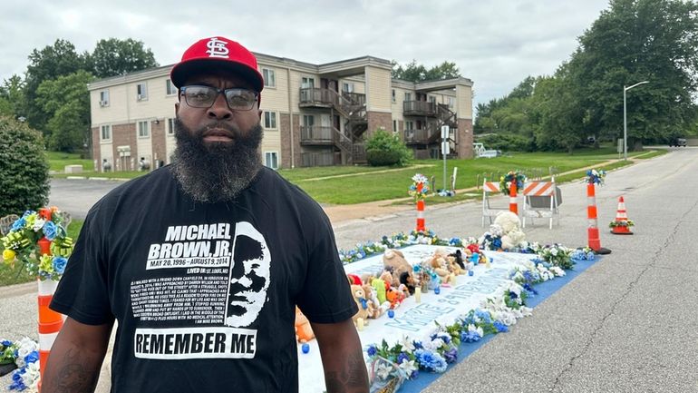 Michael Brown Sr. stands near the memorial to his son...