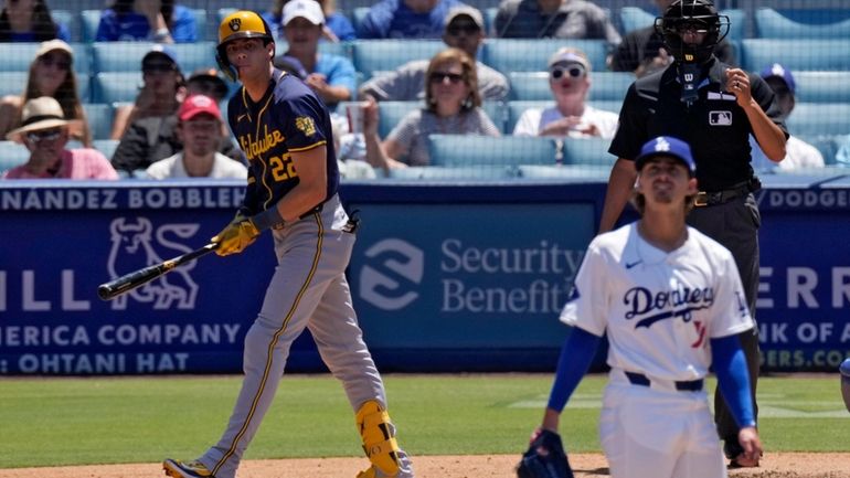 Milwaukee Brewers' Christian Yelich, left, heads to first for a...