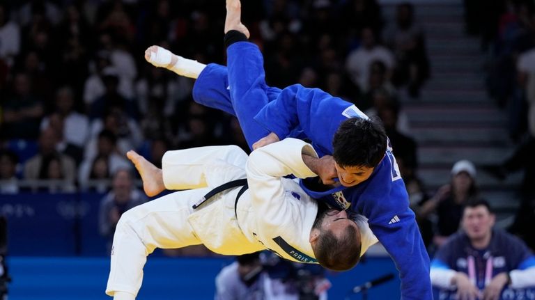 South Korea's Won Jin Kim, right, and France's Luka Mkheidze...