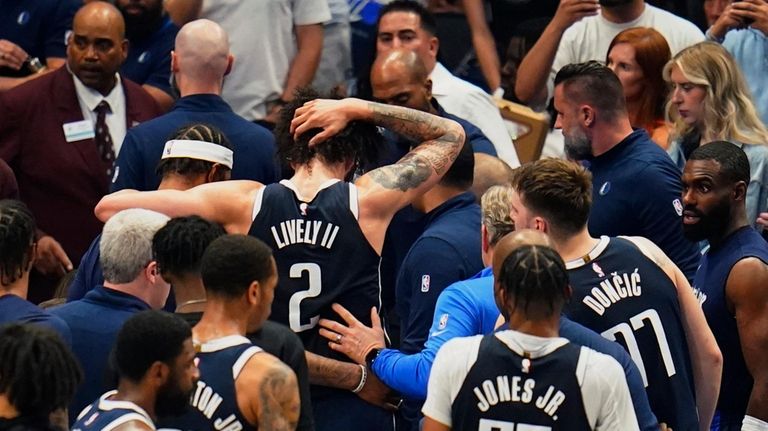 Dallas Mavericks center Dereck Lively II (2) is helped off...