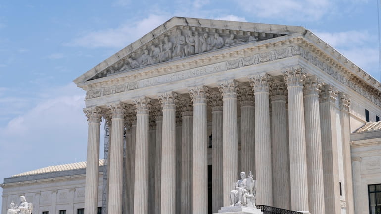 The Supreme Court is seen under a clearing sky, Friday,...
