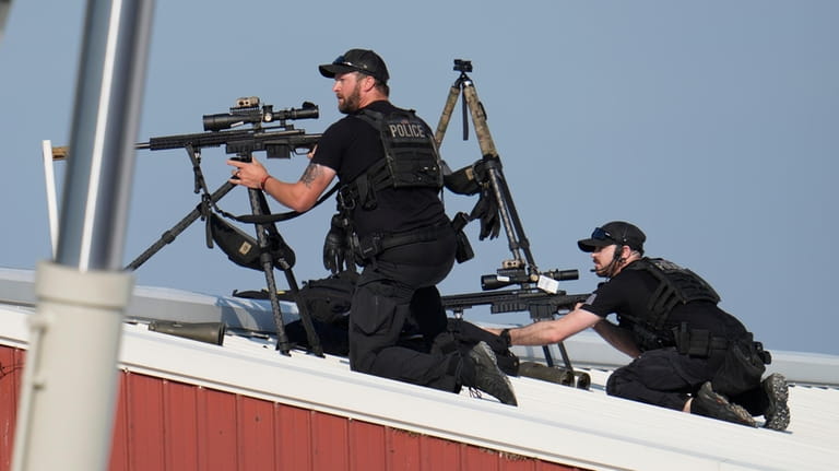 Police snipers return fire after shots were fired while Republican...