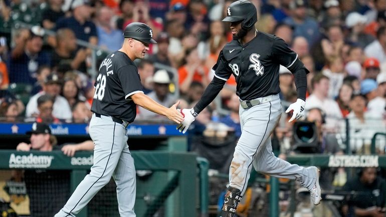 Chicago White Sox's Luis Robert Jr., right, celebrates after his...