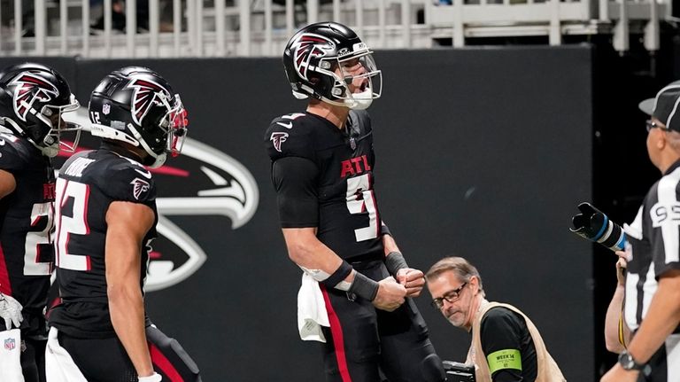 Atlanta Falcons quarterback Desmond Ridder (9) reacts after running for...