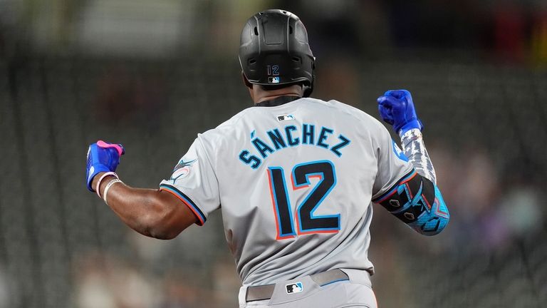 Miami Marlins' Jesus Sachez gestures as he circles the bases...