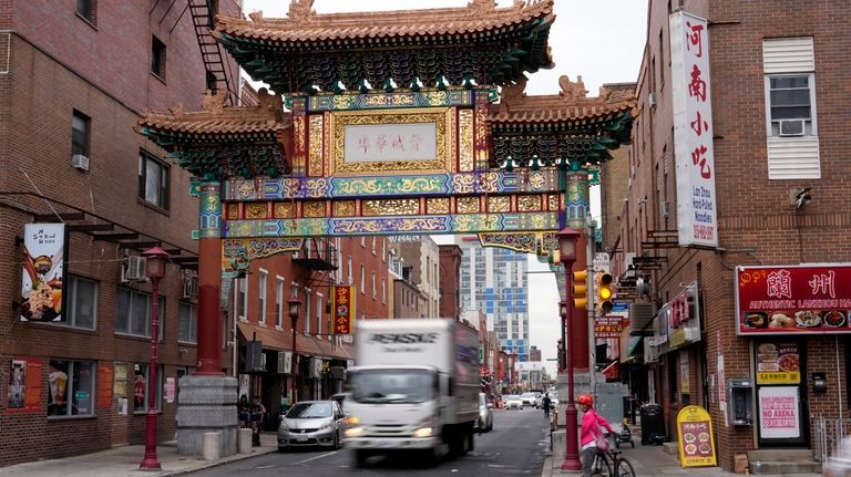 People pass through the Chinatown neighborhood of Philadelphia, Wednesday, Sept....