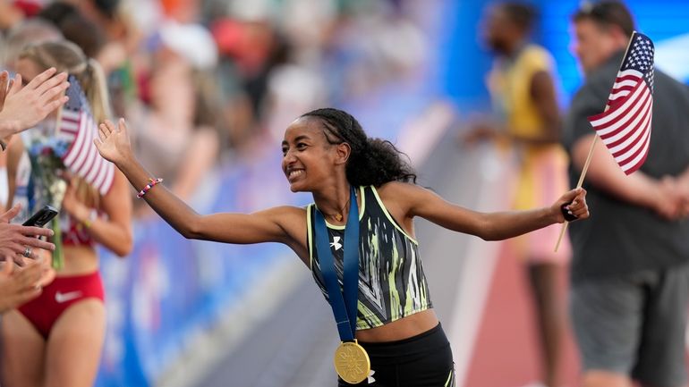 Weini Kelati celebrates after winning the women's 10,000-meter final during...