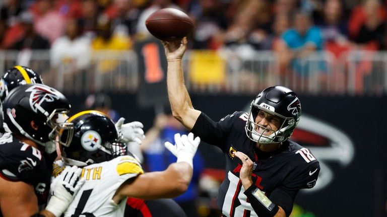 Atlanta Falcons quarterback Kirk Cousins (18) throws under pressure against...