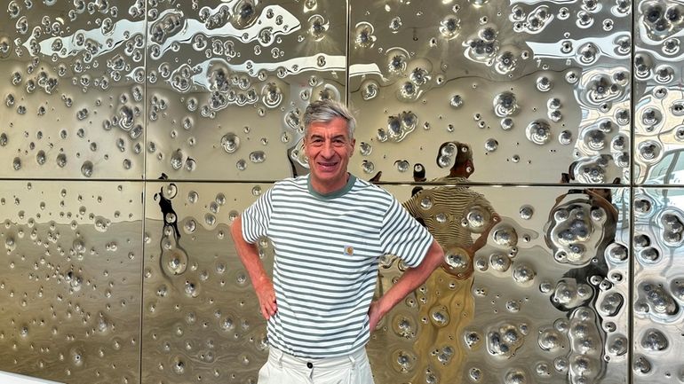 Italian artist Maurizio Cattelan poses with his installation, "Sunday," at...