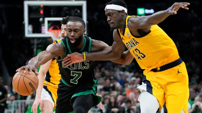Boston Celtics guard Jaylen Brown (7) is defended by Indiana...