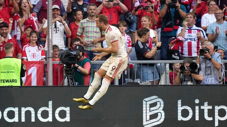 Bayern's Harry Kane celebrates after scoring the opening goal during...