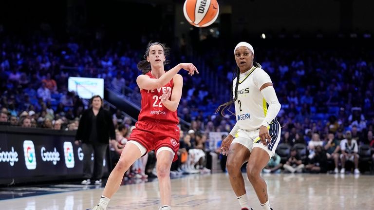 Indiana Fever's Caitlin Clark (22) makes a pass to as...