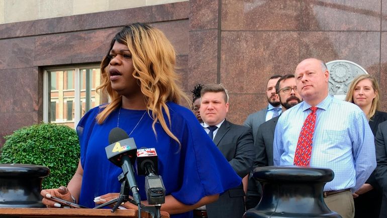 Lead plaintiff Kayla Gore speaks at a news conference outside...