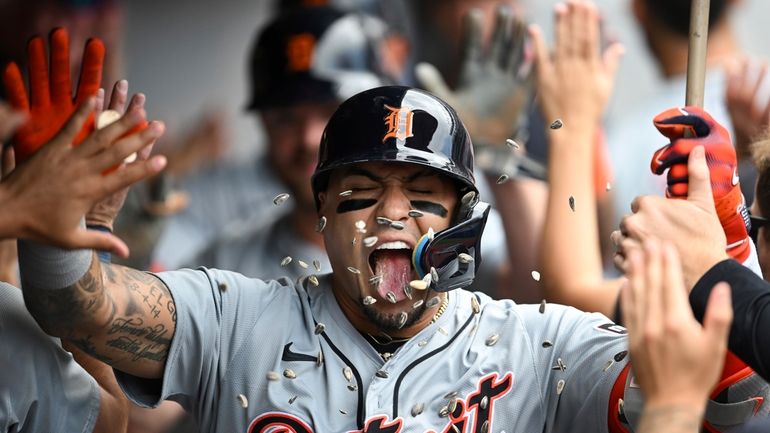 Detroit Tigers' Javier Báez celebrates with teammates after hitting a...