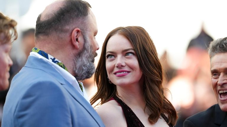 Director Yorgos Lanthimos, left, and Emma Stone pose for photographers...