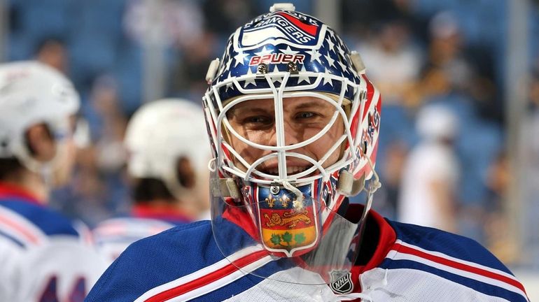 Martin Biron of the Rangers warms up to play the...