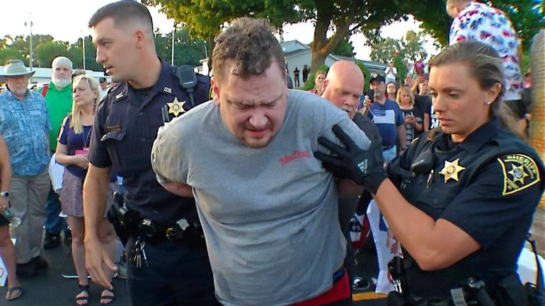 David Jakubonis is taken into custody by Monroe County sheriff deputies...