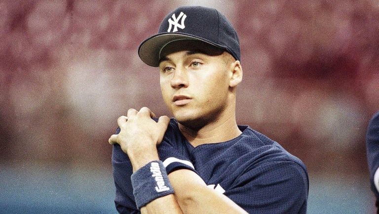 Derek Jeter warms up before making his MLB debut with...